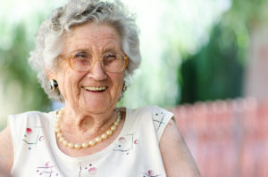 old woman laughing and learning about the benefits of assisted living