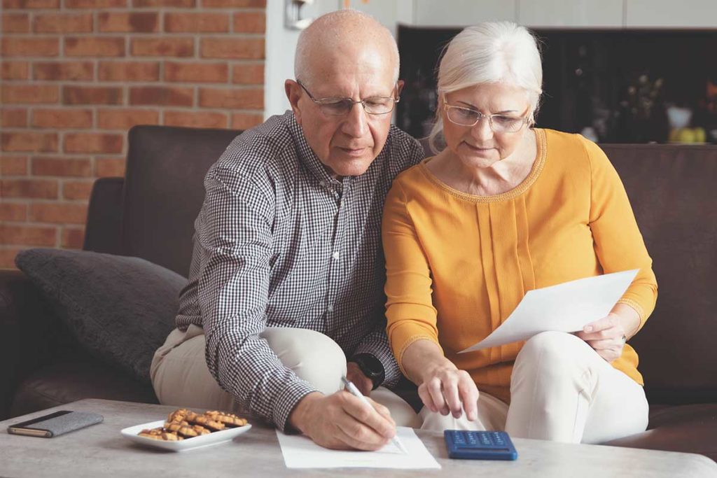 a woman and a man talking about tips for paying for senior living