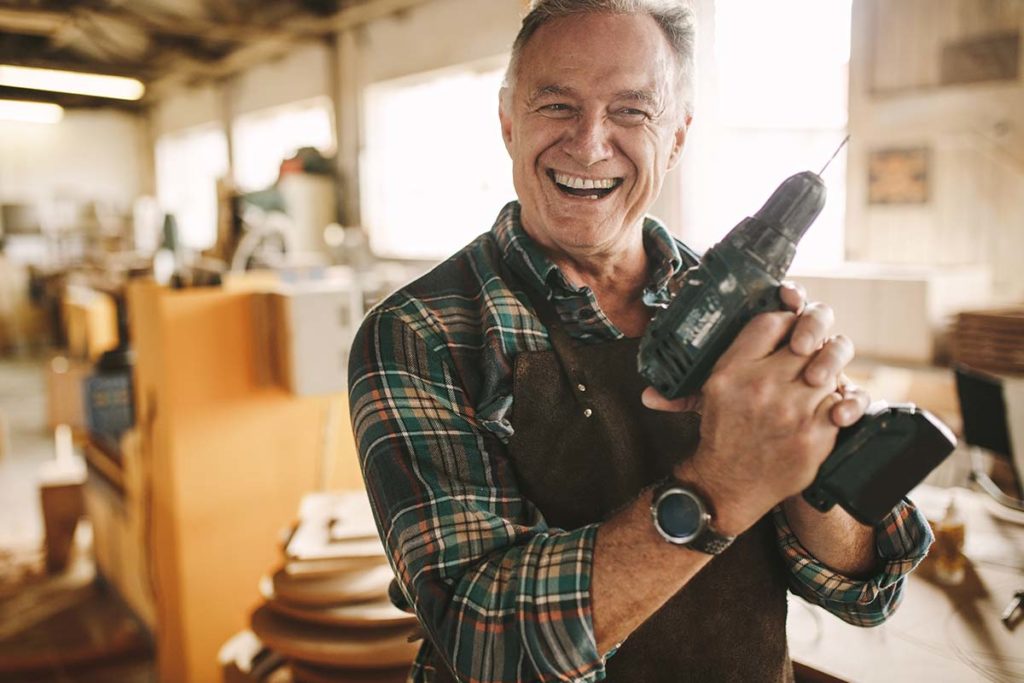 senior-smiling-with-drill-is-why-seniors-should-learn-new-skills -of-