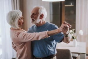 a senior couple thrives and dances in senior living