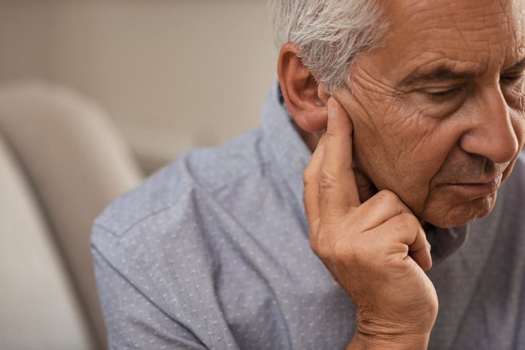 an elderly man struggles to cope with his hearing loss and seeks to find the root cause of it to treat it