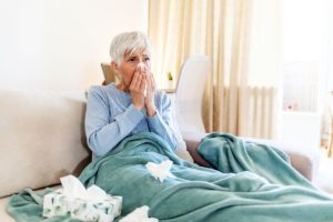 a senior woman shows signs of potentially having pneumonia but fortunately she knows the signs to look out for thanks to her health and wellness program
