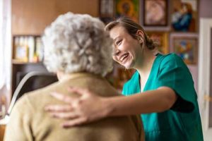 a woman cares for an elderly resident in assisted living