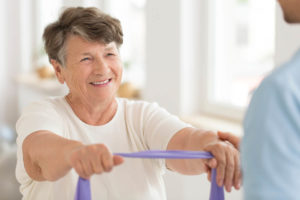 an elderly woman begins to see the benefits of her physical therapy program pay off