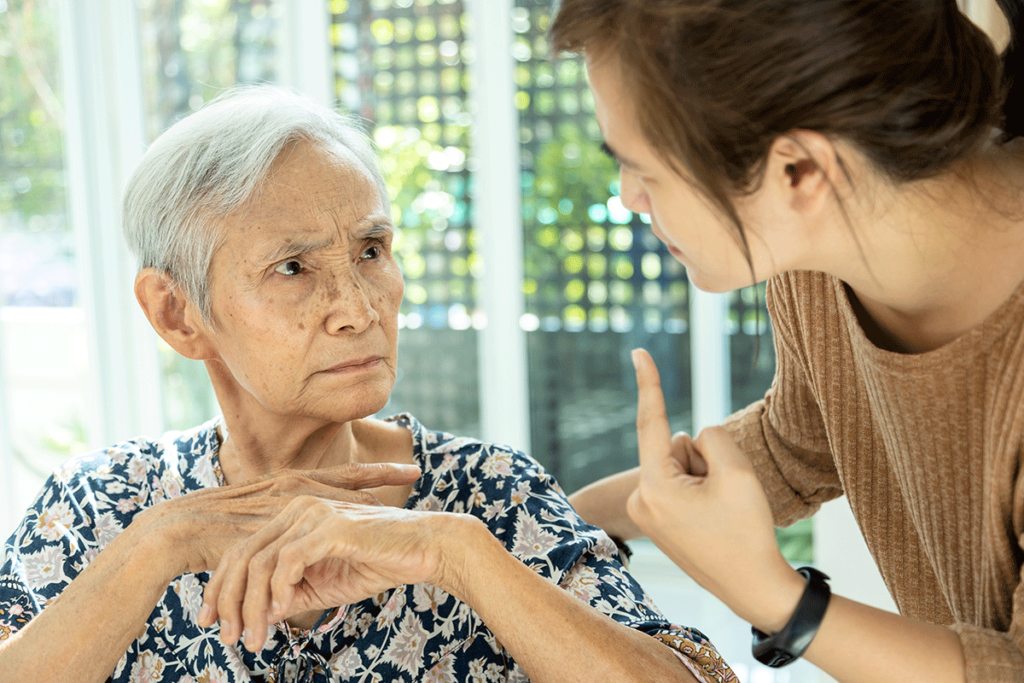 Senior adult talking to nurse while showing signs of dementia