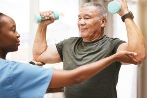 Man lifts weights while learning the importance of physical therapy for seniors