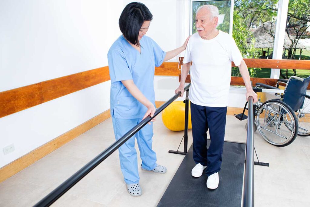 Nurse helps senior maintain his mobility aas he learns what occupational therapy is
