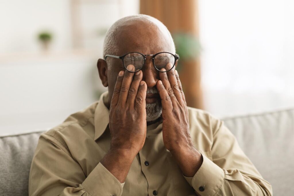 Man reaches up to feel his eyes as her learns how poor nutrition affect the elderly