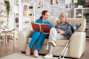 Senior talks to nurse on couch about a new senior assisted living in Houston TX