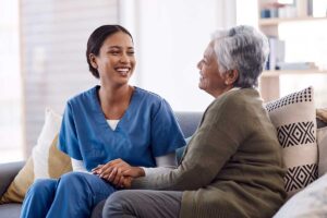 Nurse talks to senior about age and health related speech issues