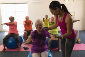 Woman talks to senior about exercise programs tailored for older adults