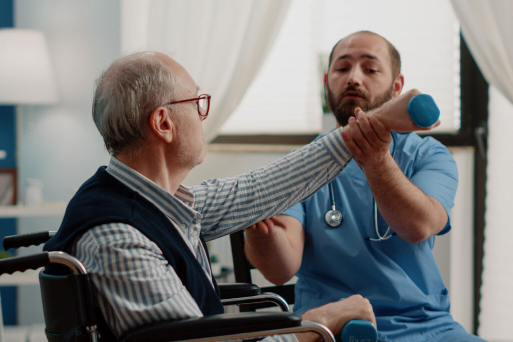 Therapist helps man stretch during physical therapy for seniors