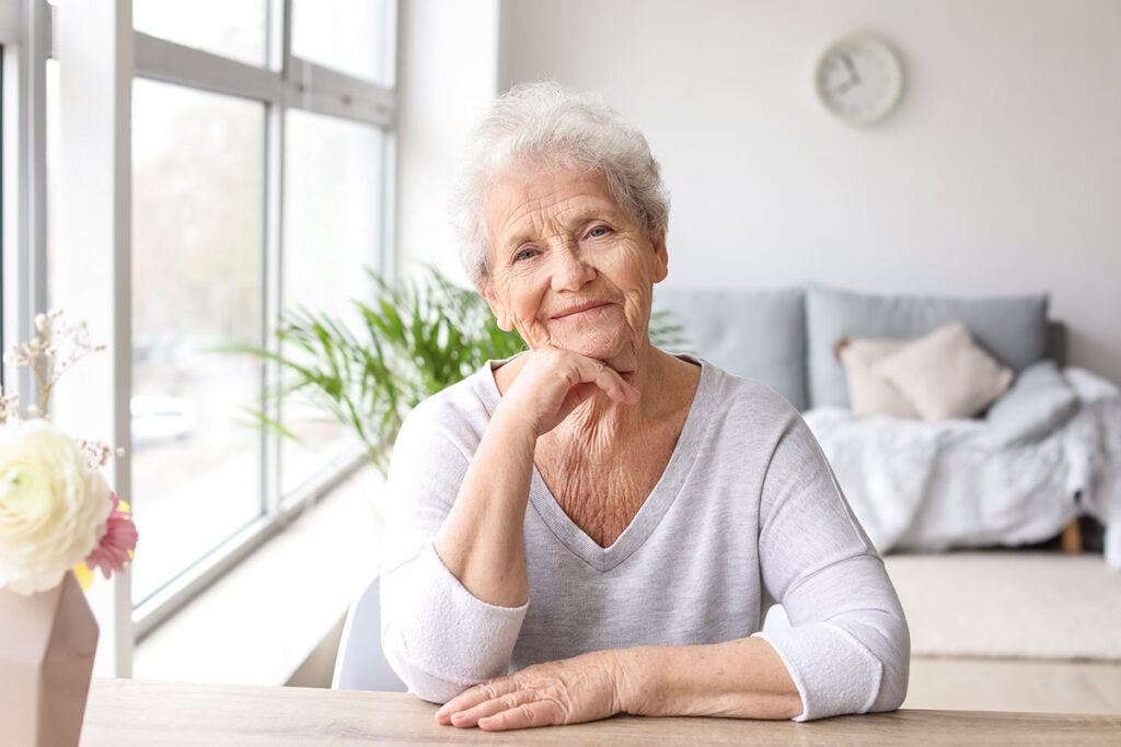 Woman smiles thinking about the levels of care offered in senior living