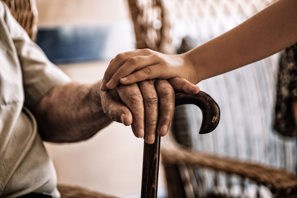 Person comforts senior during quality care in assisted living