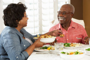 Couple shares dinner while discussing nutrition and preventing age-related diseases